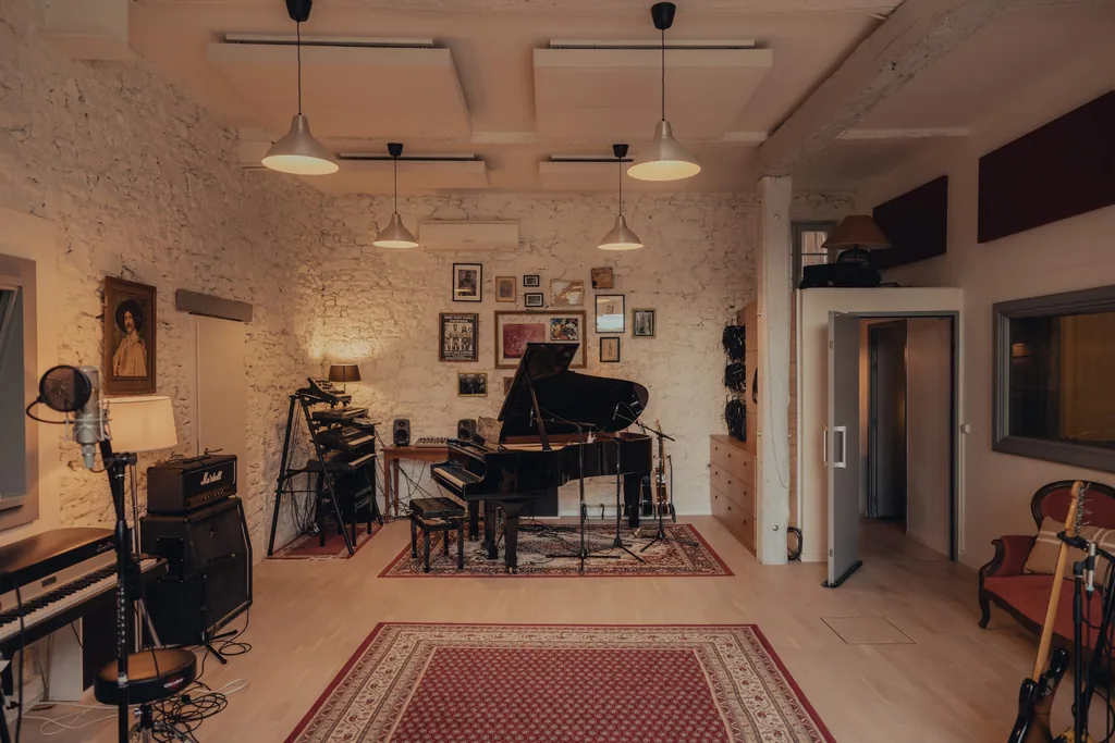 Live room with grand piano, drum kit and recording equipment in Limusic residential recording studio, Limoux southern France