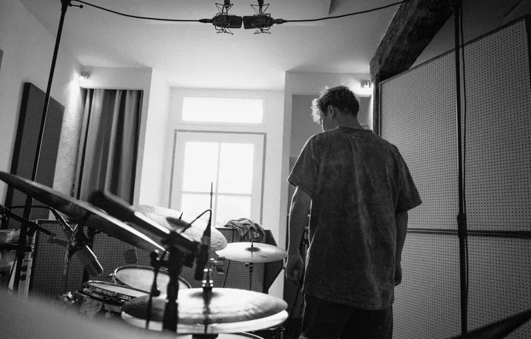 Musician recording drums in a professional studio at Limusic residential recording studio in Limoux, southern France