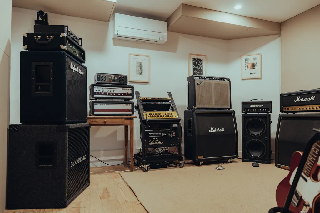 Backline equipment and amplifiers in a residential recording studio live room at Limusic in southern France