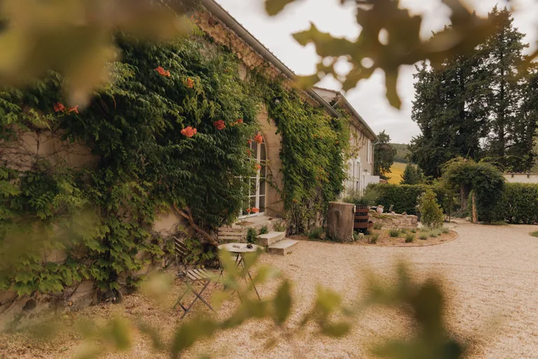 Ivy-covered stone building at Limusic residential recording studio in Limoux, southern France, surrounded by gardens and courtyard