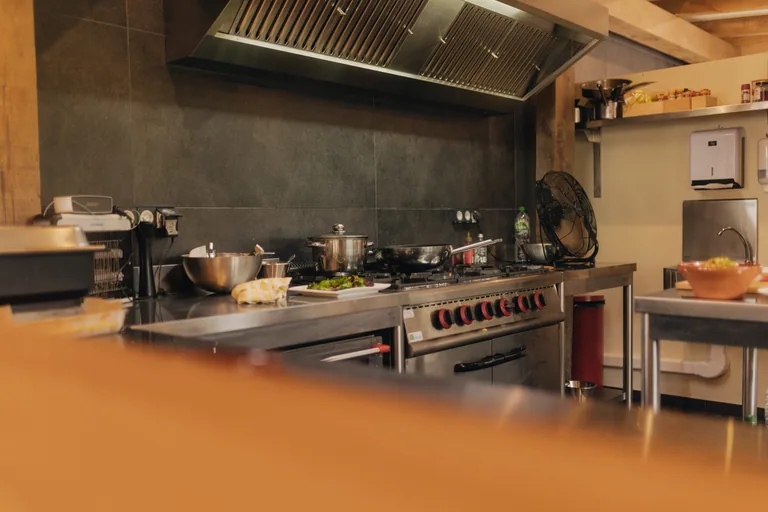 Professional kitchen at Limusic Residential Recording Studio with commercial stove, prep stations, and catering equipment for all-inclusive recording sessions in Limoux, France