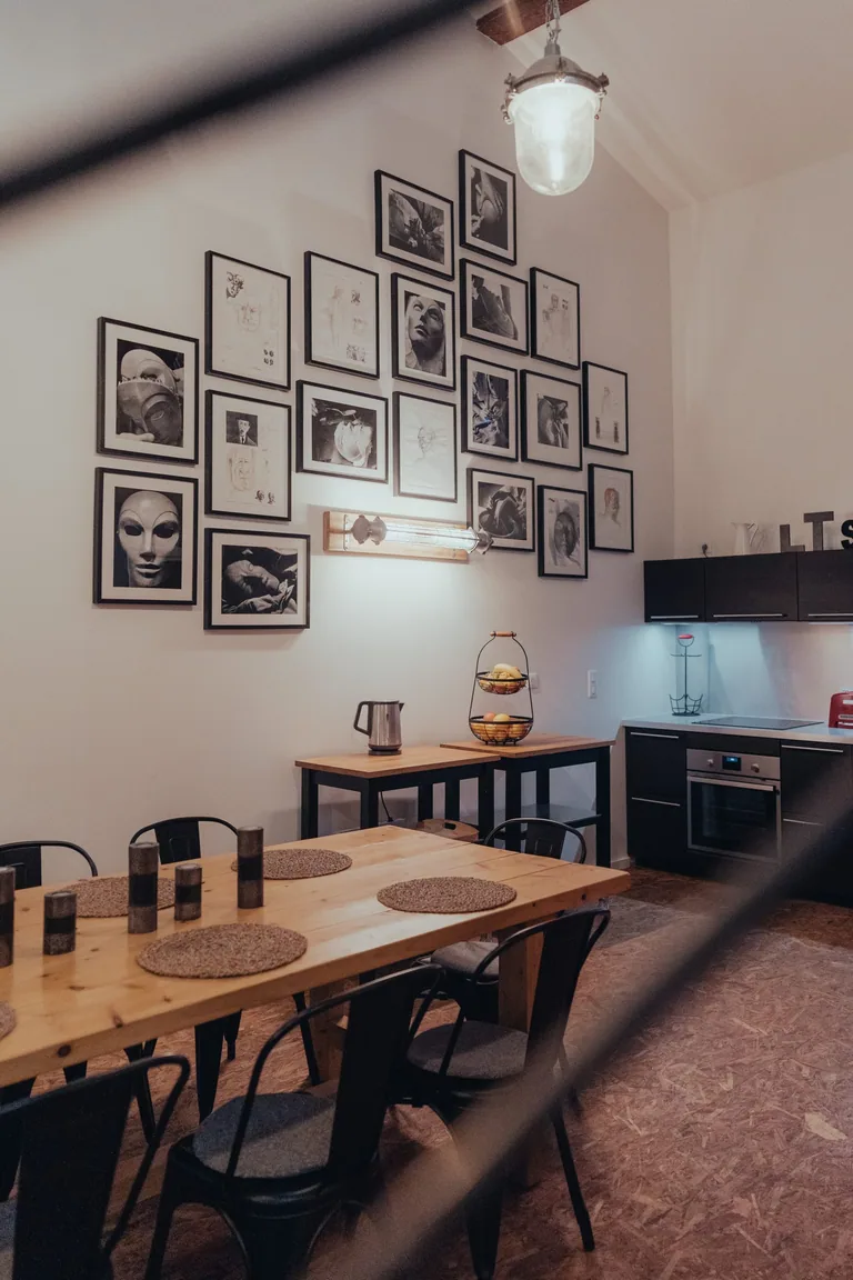 Dining area in Limusic Residential Recording Studio apartment with wooden table, gallery wall, and modern kitchen in southern France