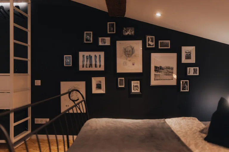 Guest bedroom at Limusic Residential Recording Studio with artistic wall gallery and comfortable bed for musicians during all-inclusive recording sessions in Limoux, France