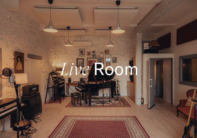 Professional live room at Limusic recording studio in southern France with grand piano, drum kit, and acoustic treatment
