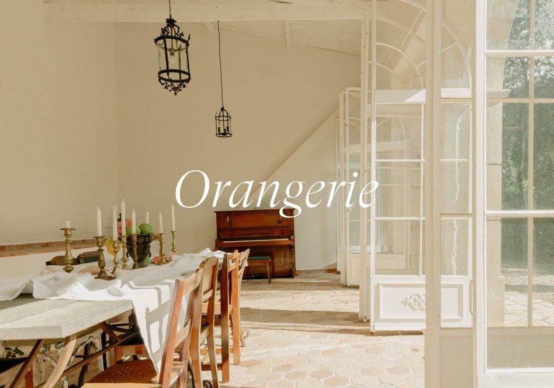 Elegant dining space in Limusic Residential Recording Studio's Orangerie with piano and French doors overlooking estate grounds
